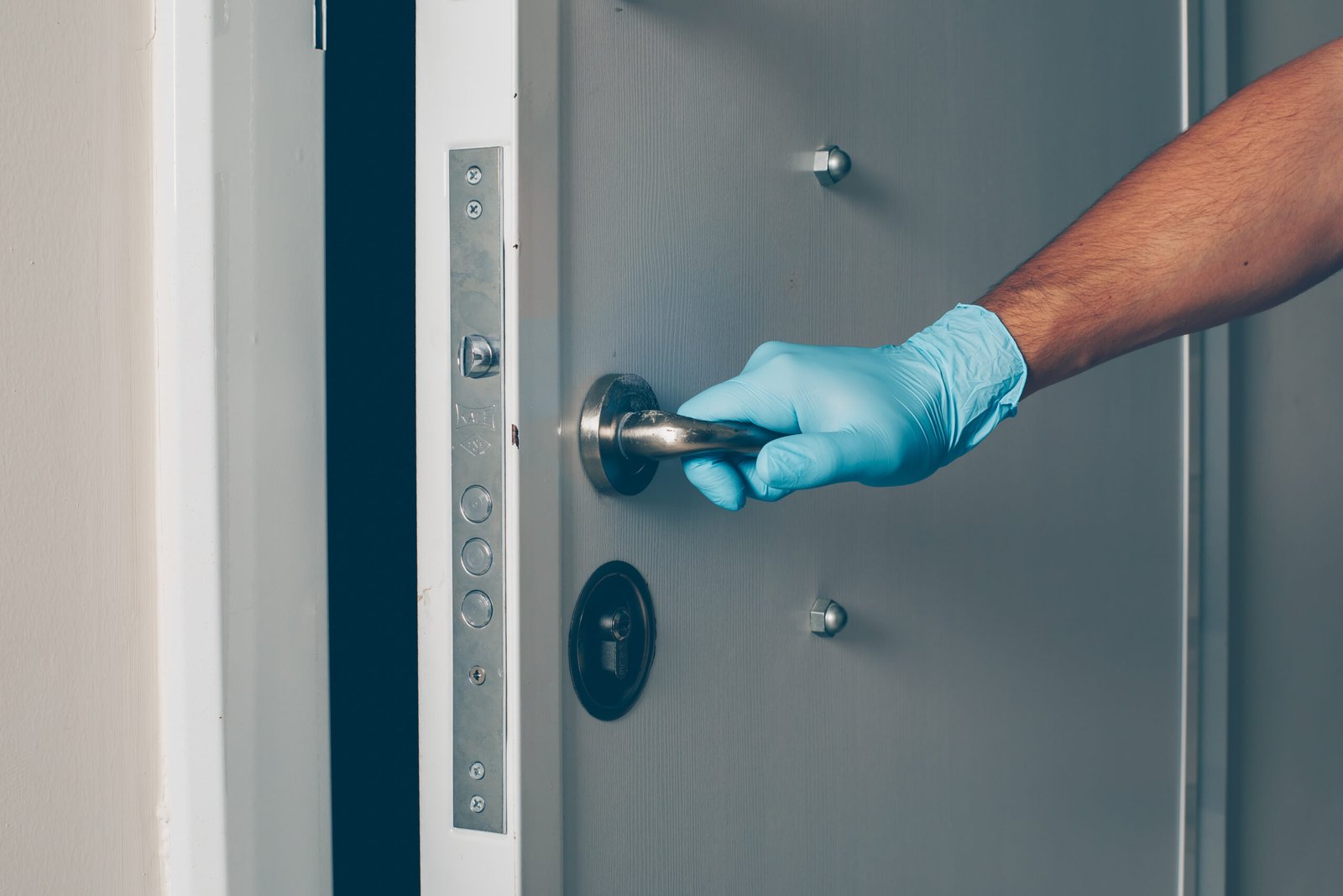 Technician replacing a door lock as part of professional locksmith, door hardware, and access control services provided by Artemis-Tek Systems Inc. in Metro Vancouver and the Fraser Valley, BC.